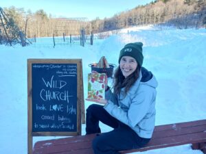 Heather Wolfe holding the book Field Guide to Church of the Wild
